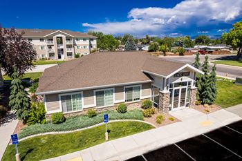 A building with a brown roof and a sign that says "Welcome" in front of it.